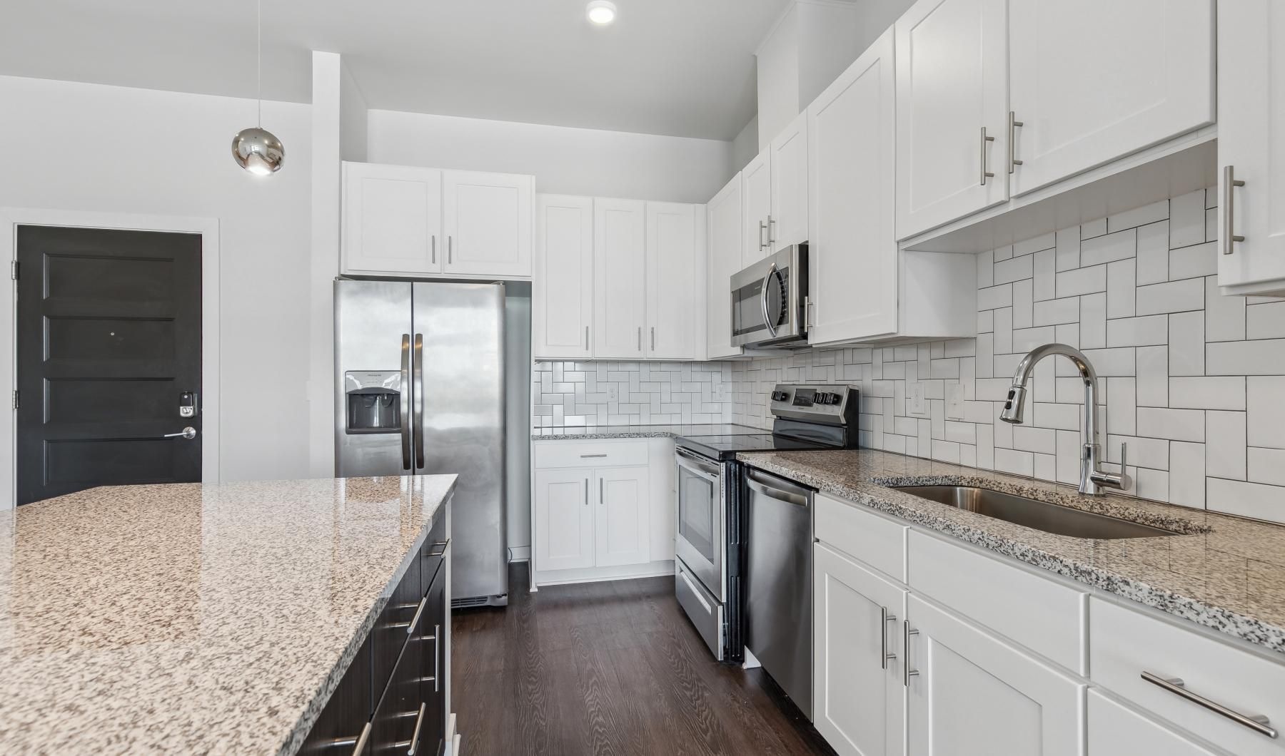 Spacious kitchens with thoughtful details a kitchen with white cabinets