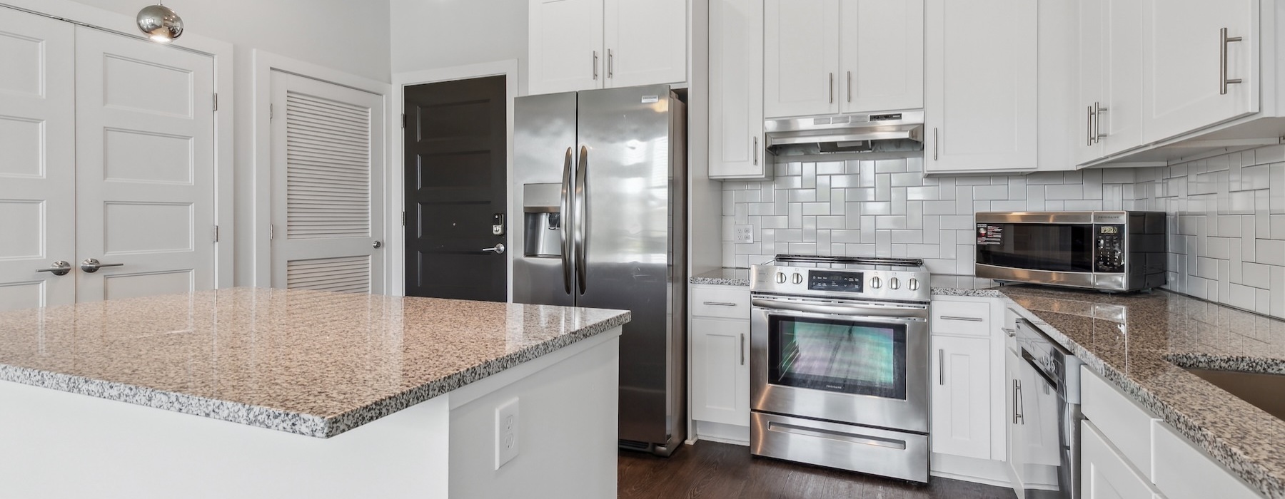 a kitchen with white cabinets
