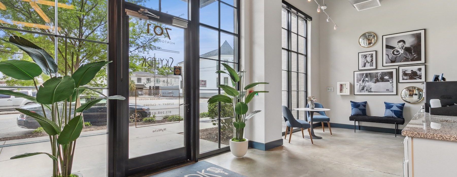 the entrance of a leasing office with flowers