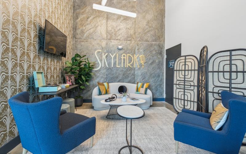 Access to resident-only features a clubroom with a couch and chairs