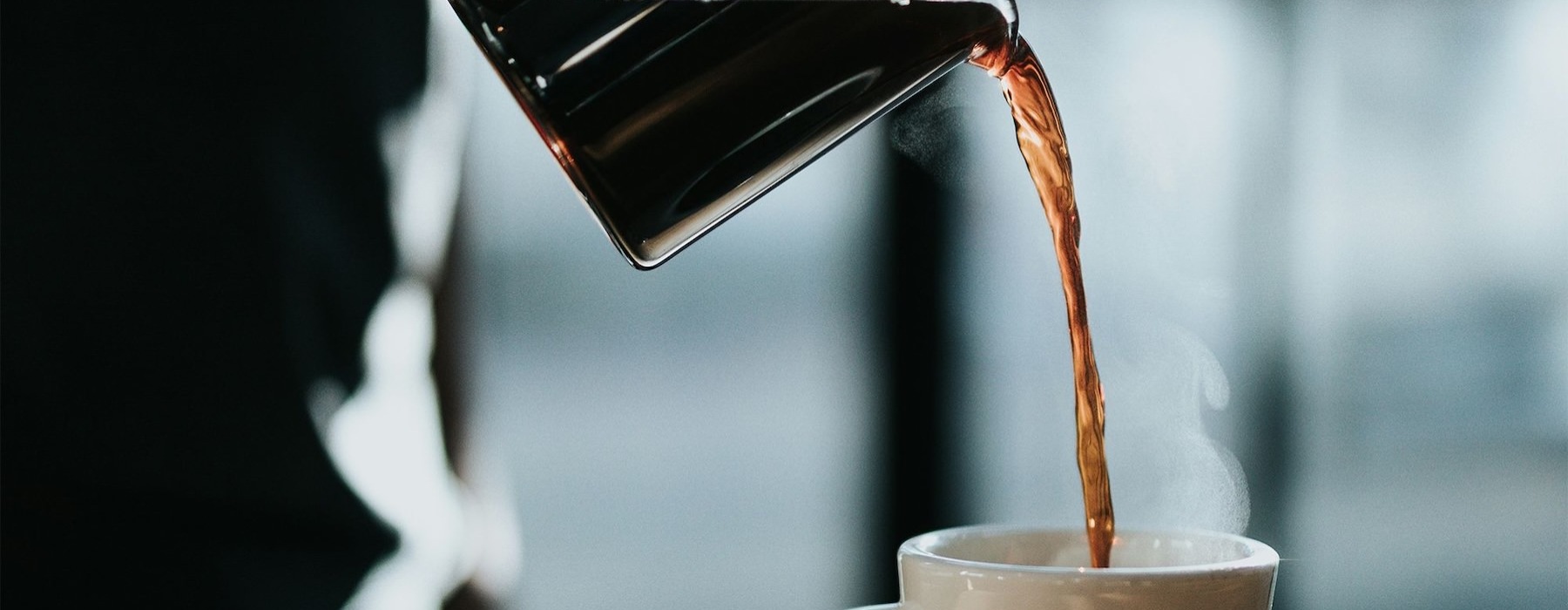 a person pouring coffee