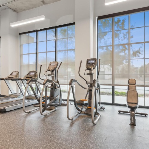 State-of-the-art amenities a gym with exercise equipment